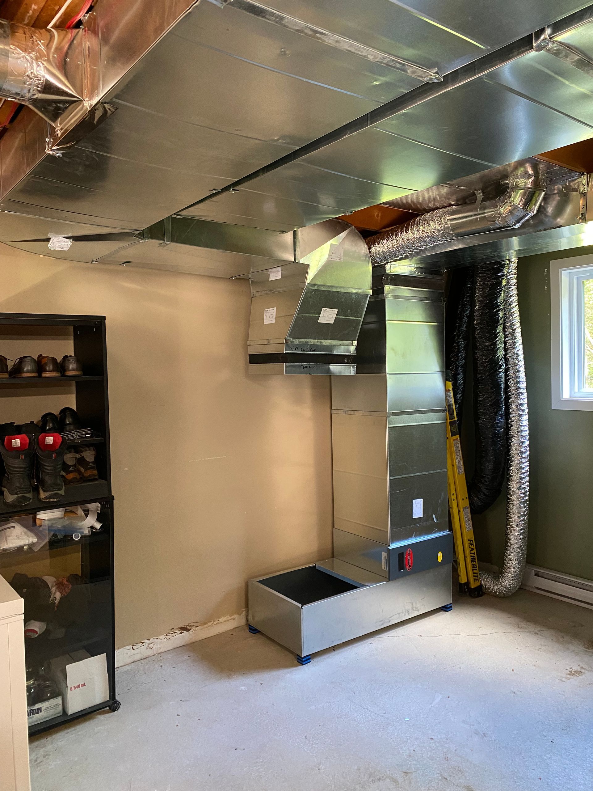 Une pièce avec beaucoup de conduits sortant du plafond.