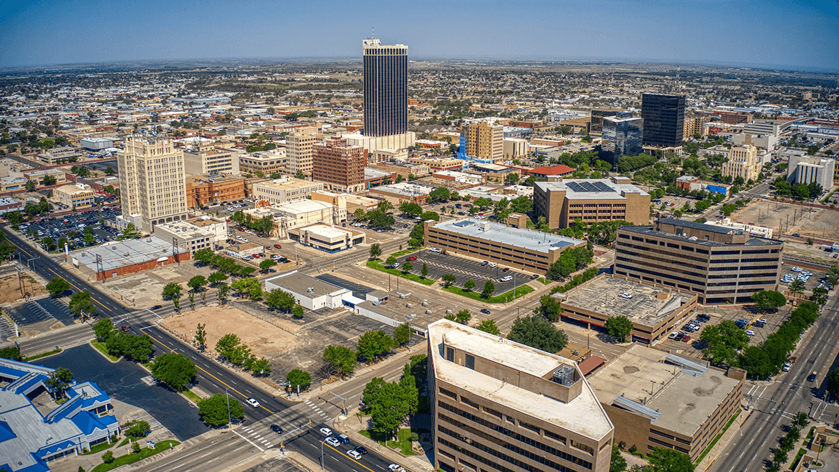 Aerial view of El Paso, Texas, downtown cityscape with tall buildings, streets, and blue sky.
