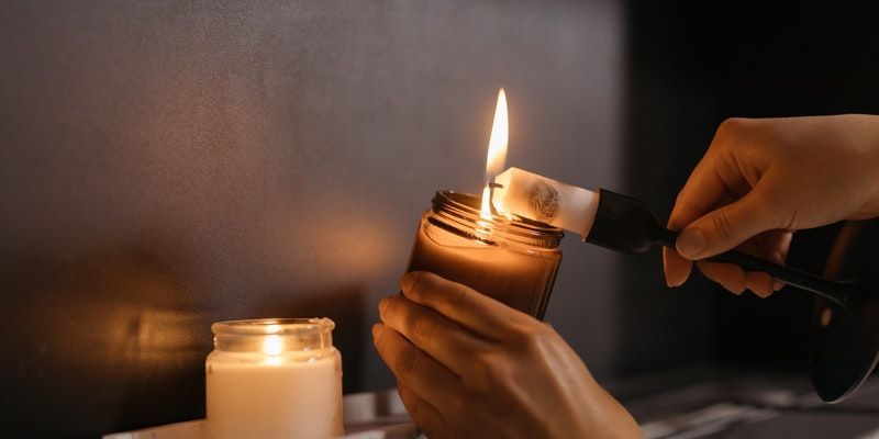 lighting a memorial candle during a funeral and cremation in Chicago, IL, symbolizing remembrance, peace, and honoring a loved one's life