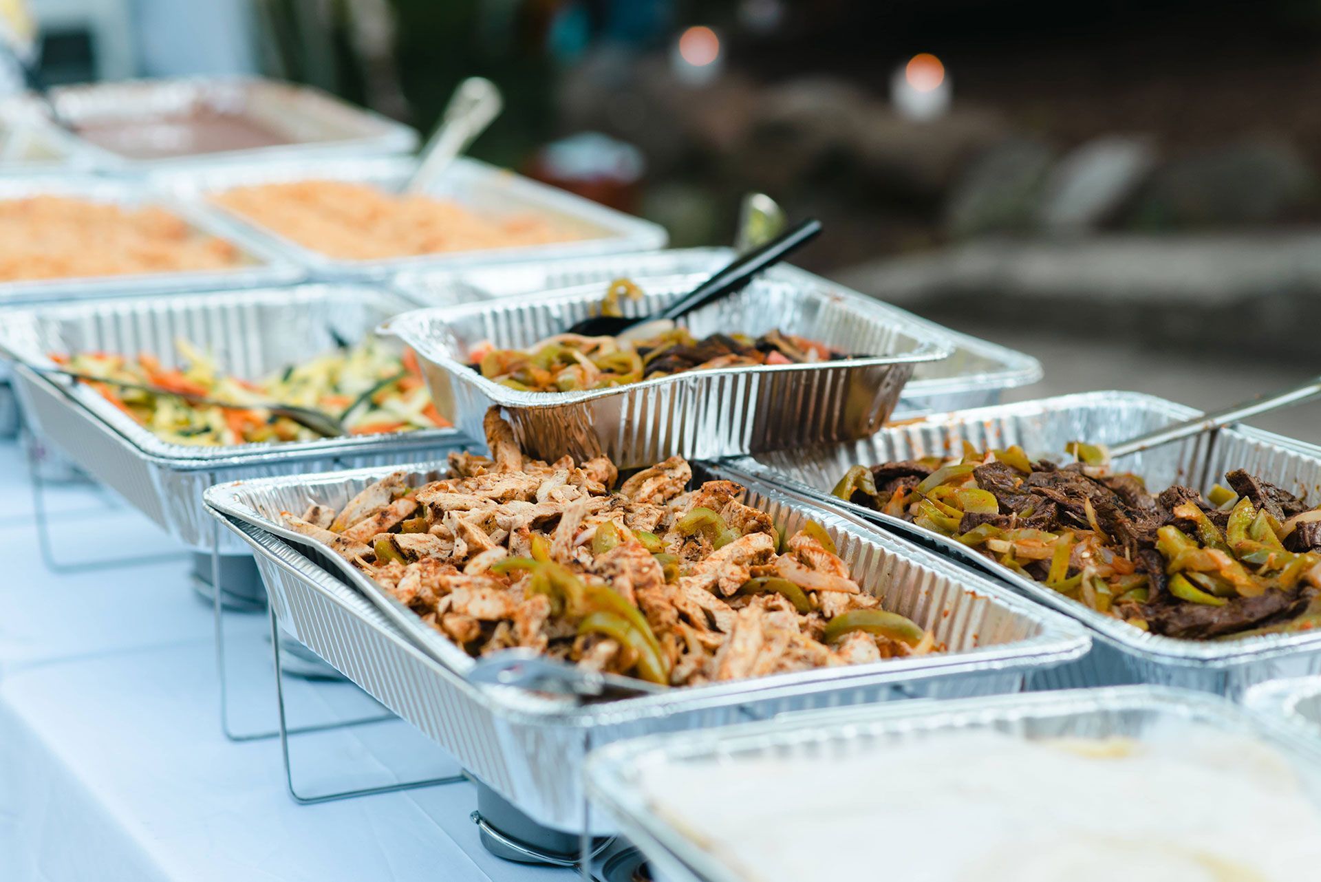 Many trays of food on the table.