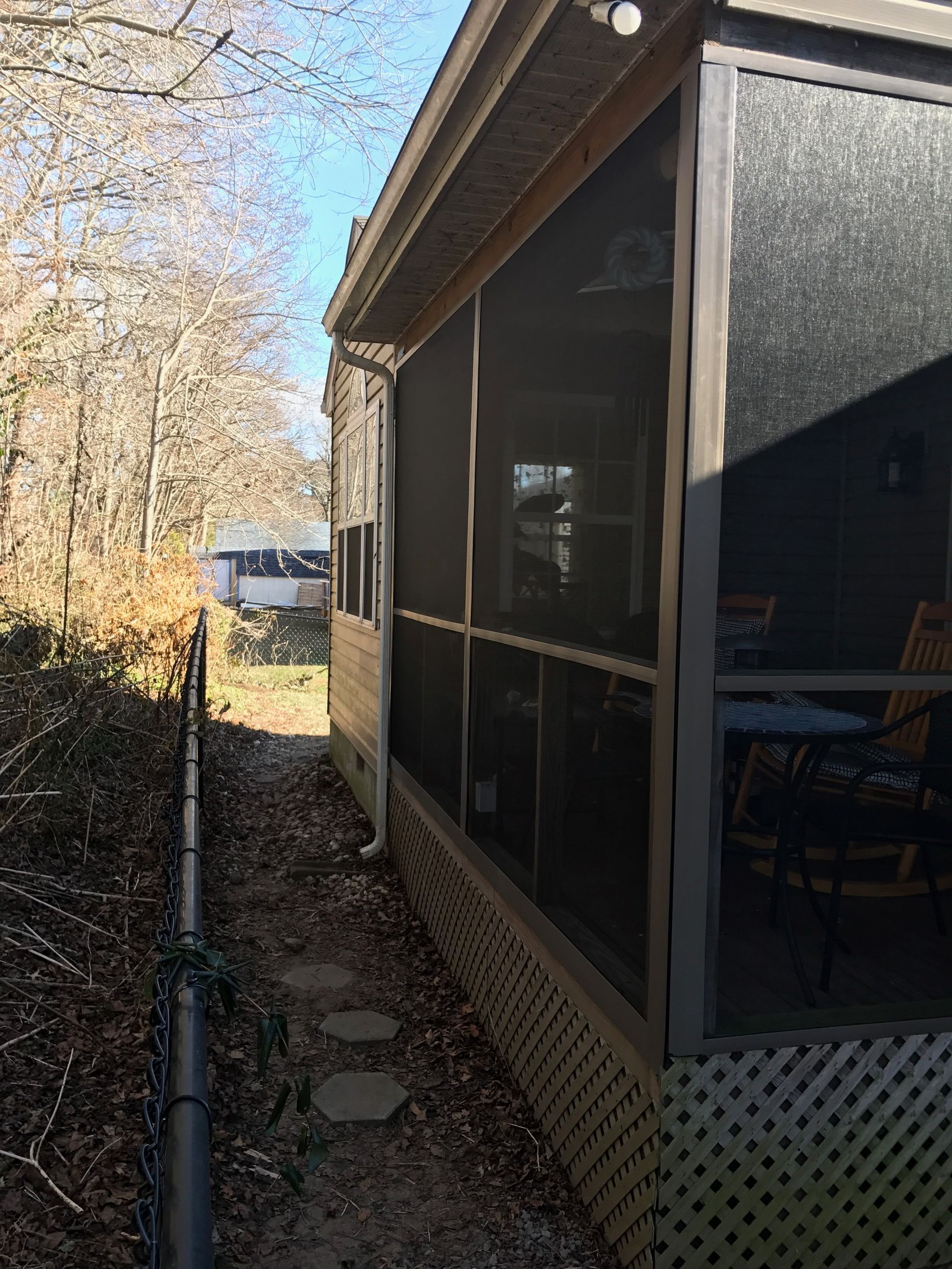 A man is installing a wooden deck with a drill