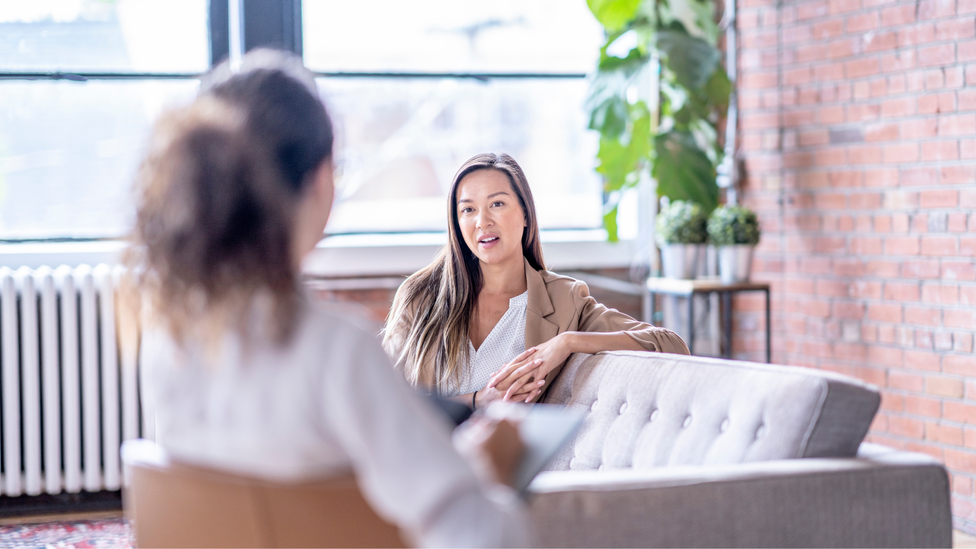 a woman is standing on the beach looking at the ocean