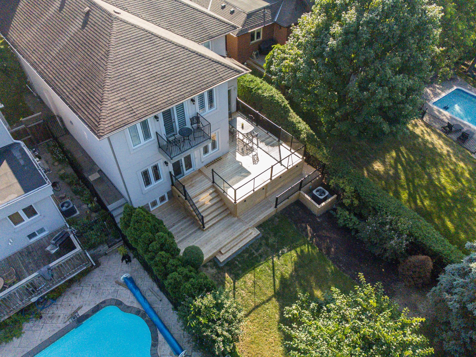 An aerial view of a house with a swimming pool in the backyard.