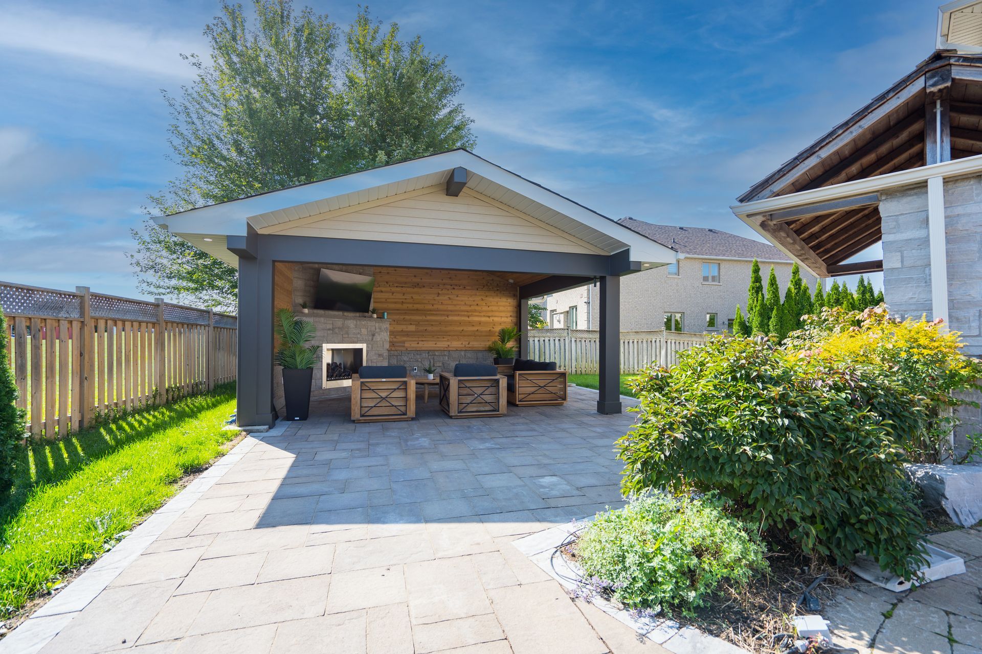 There is a gazebo in the backyard of a house.
