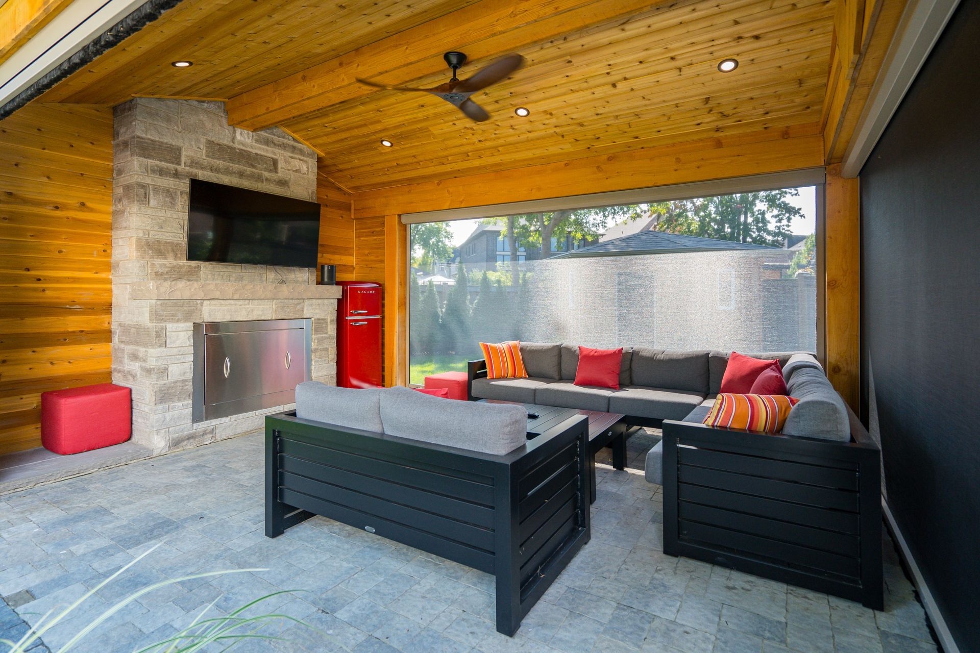 A living room with a couch , chairs and a fireplace.