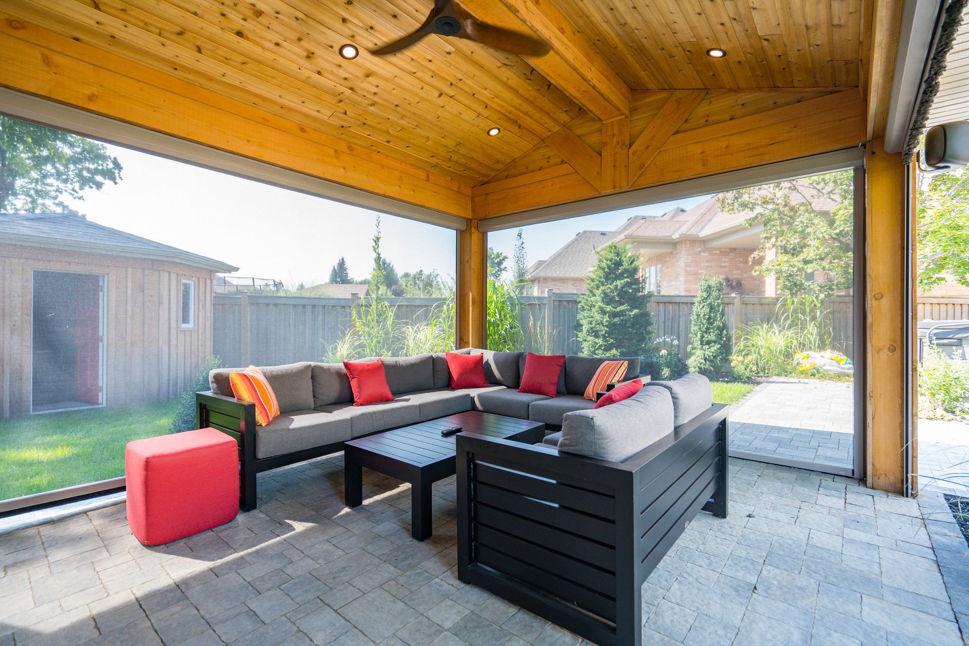 A living room with a couch , chairs , table and a ceiling fan.