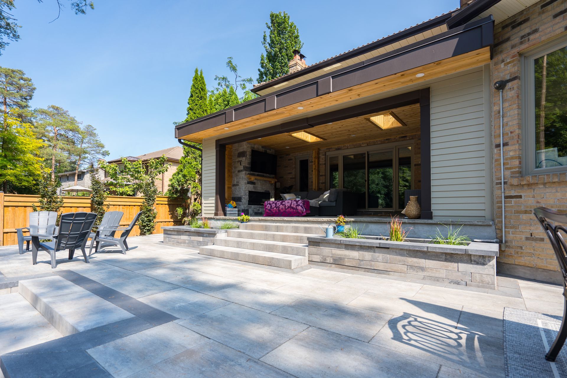The backyard of a house with a patio and chairs.