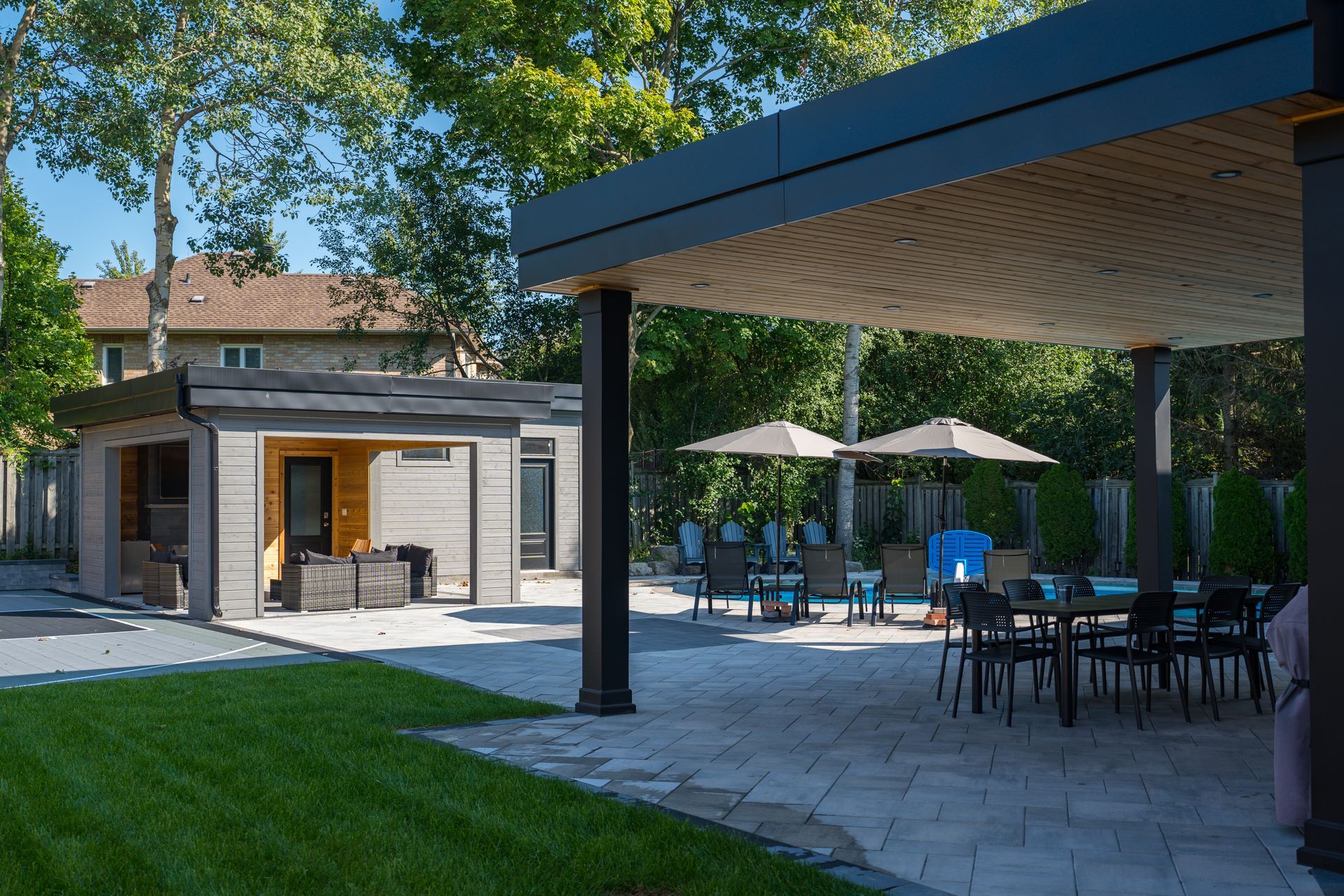 A patio area with tables and chairs under a canopy