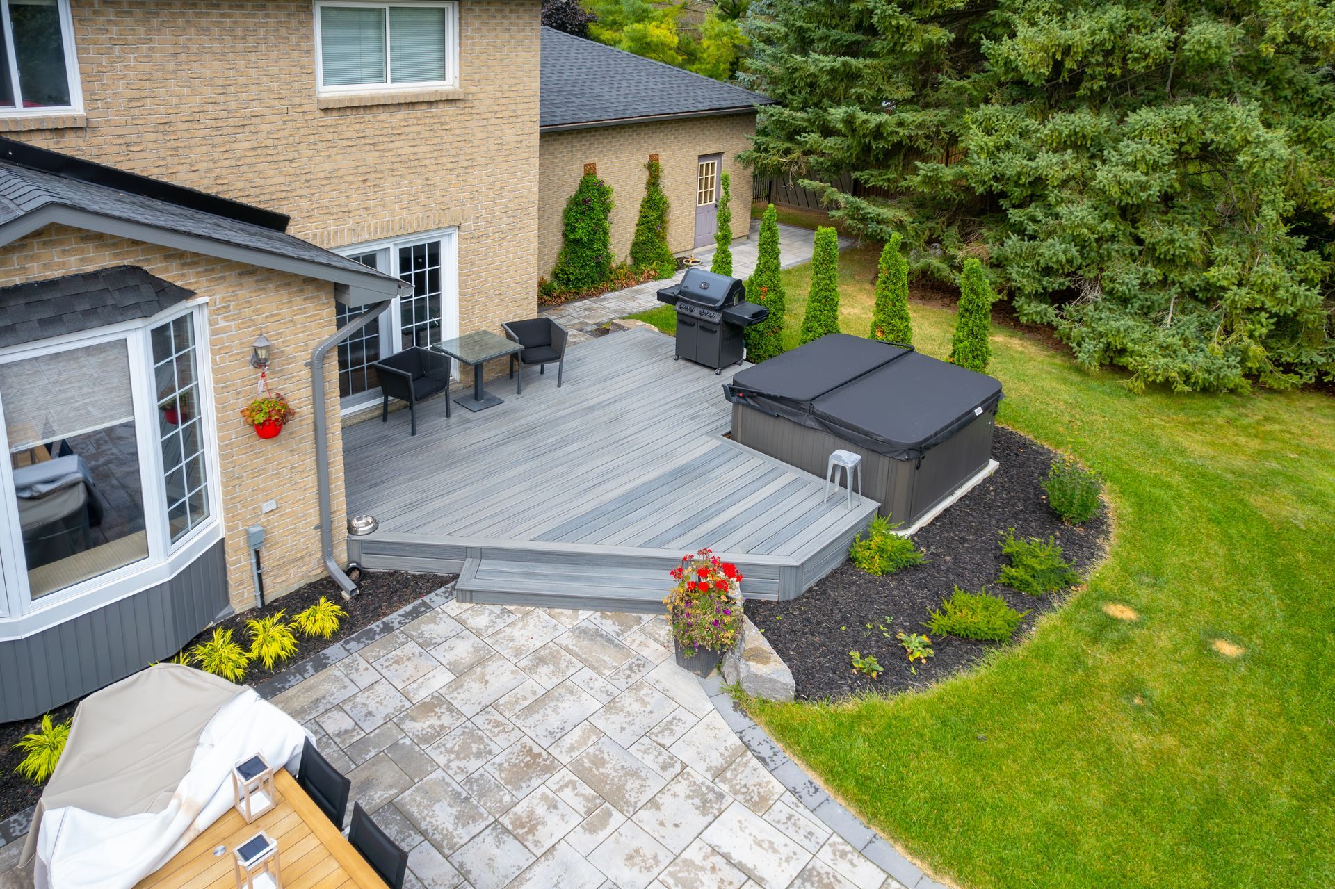 An aerial view of a backyard with a patio and a hot tub.
