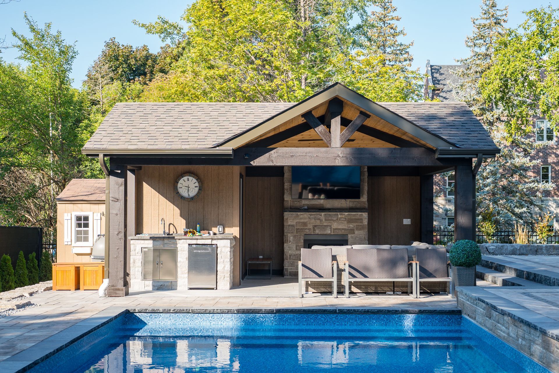 A house with a swimming pool in front of it.