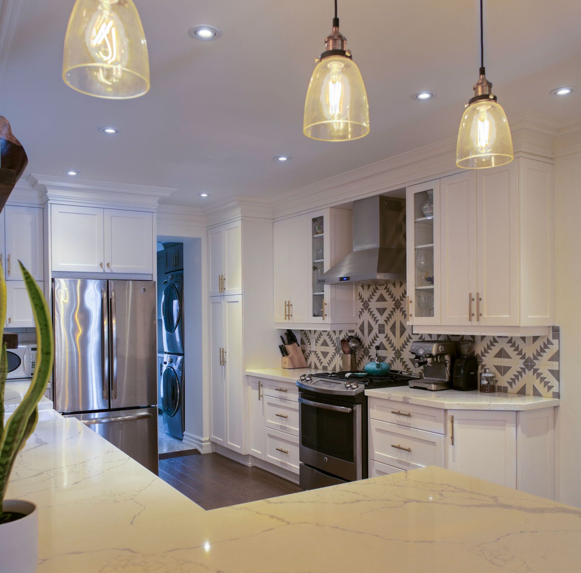 A kitchen with white cabinets and stainless steel appliances