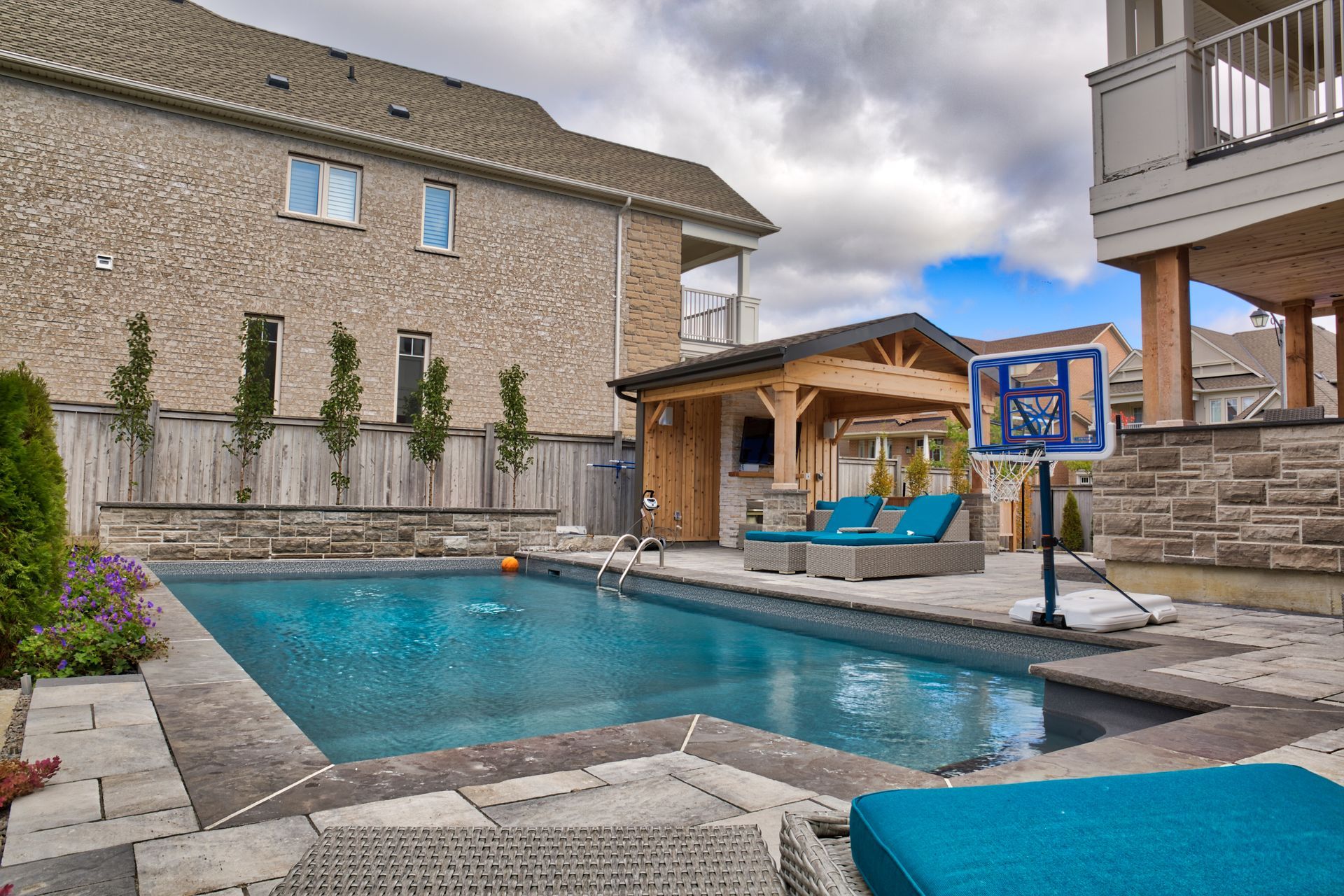 A large swimming pool in the backyard of a house