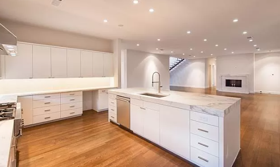There is a large island in the middle of the kitchen.