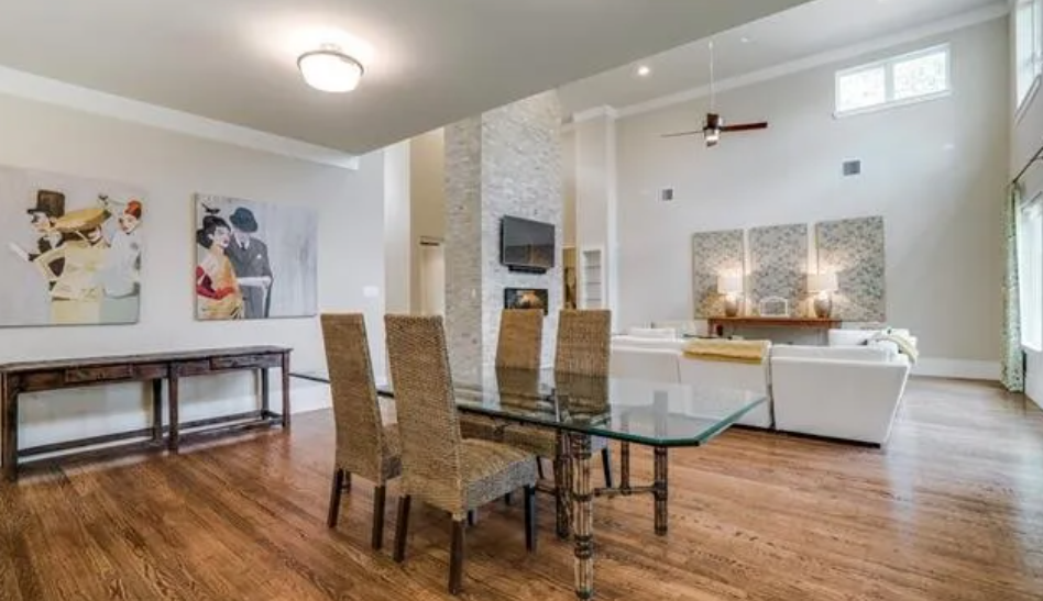 There is a dining table and chairs in the middle of the room.