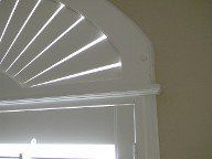 A close up of a window with shutters on it.