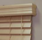 A close up of a wooden blind with a white trim.