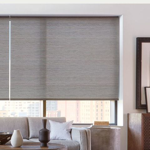 A living room with a couch , chair , table and mirror.