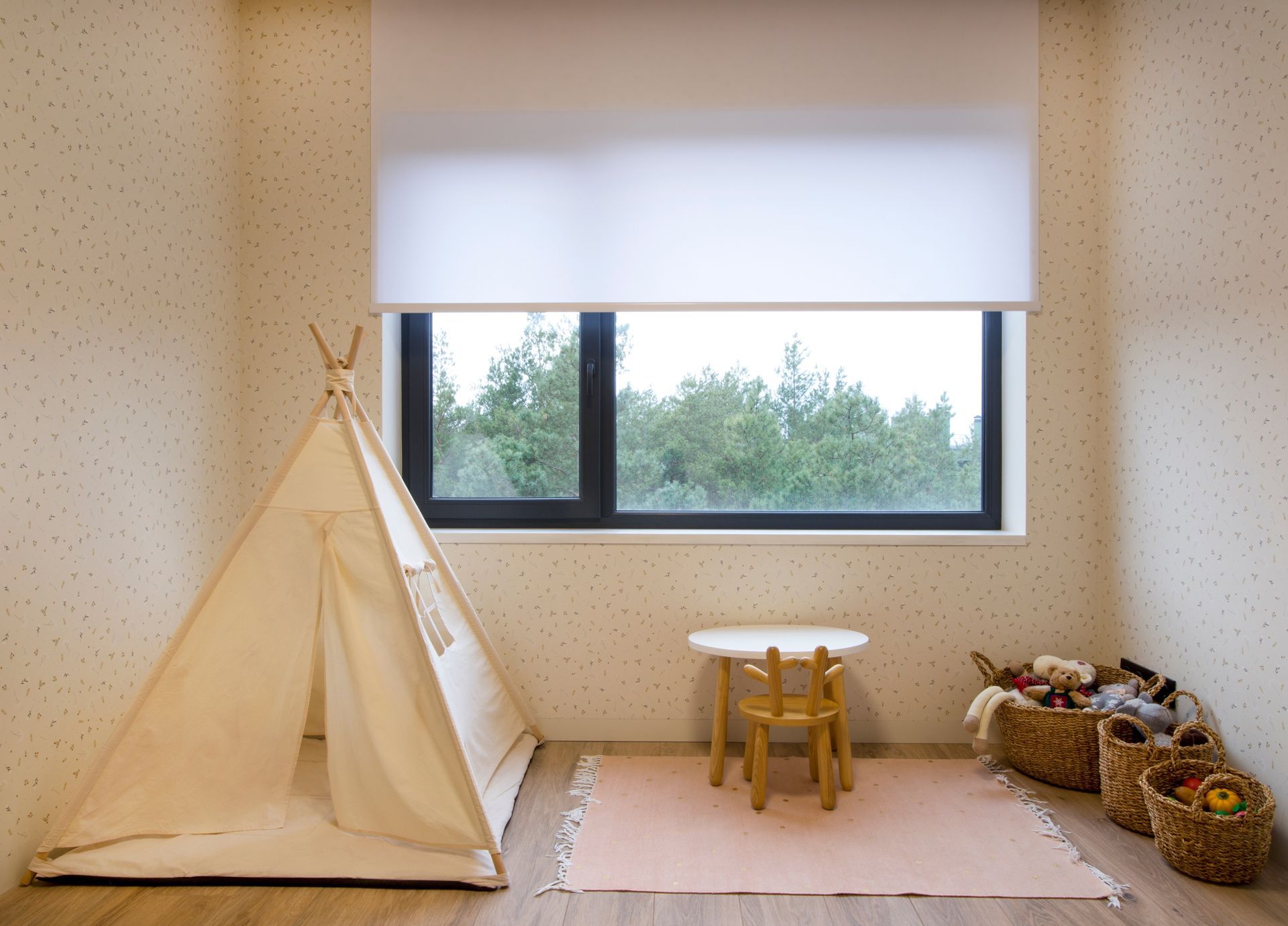 A child 's room with a teepee , table and chairs.