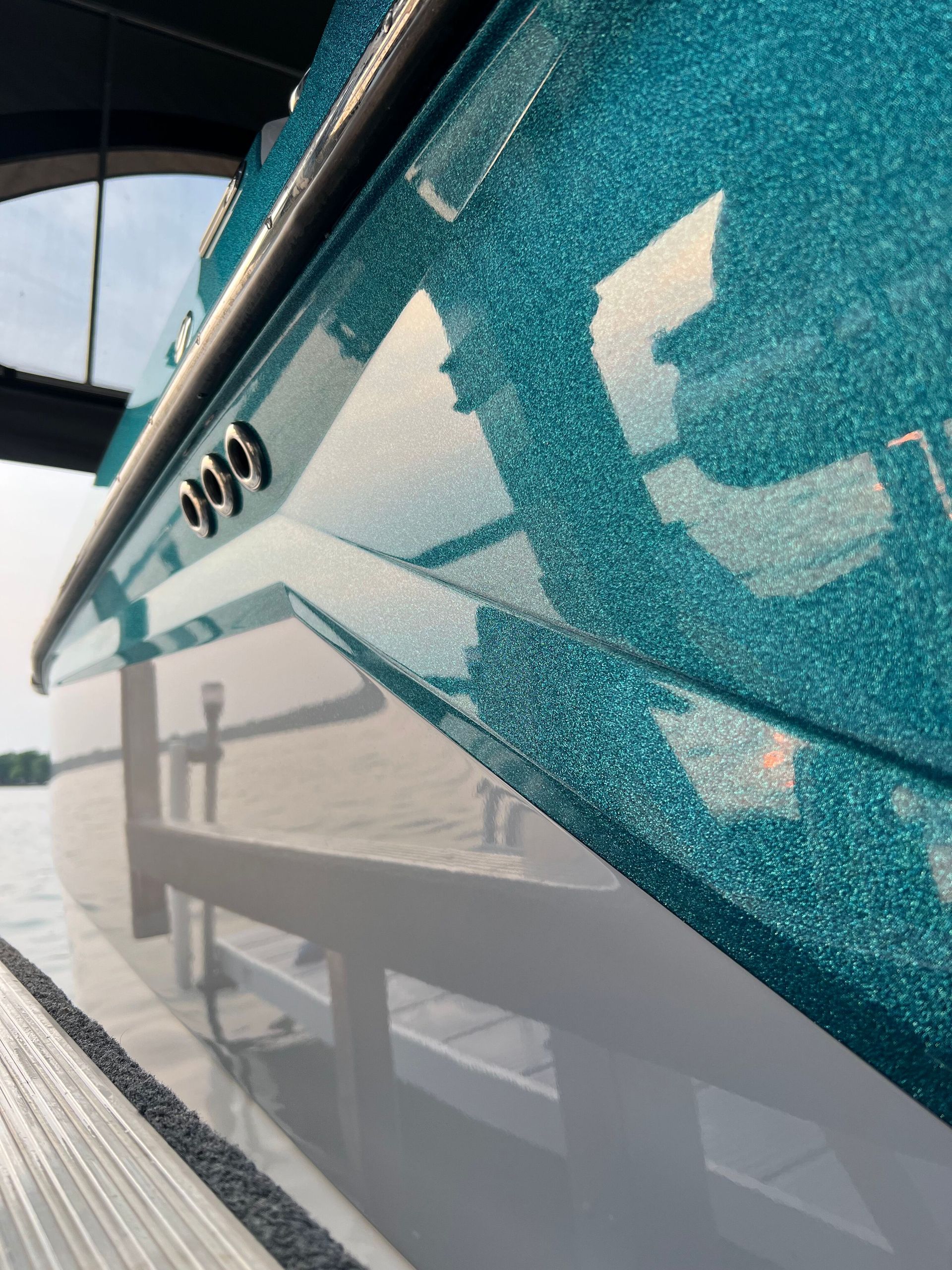 A close up of the side of a blue and white boat