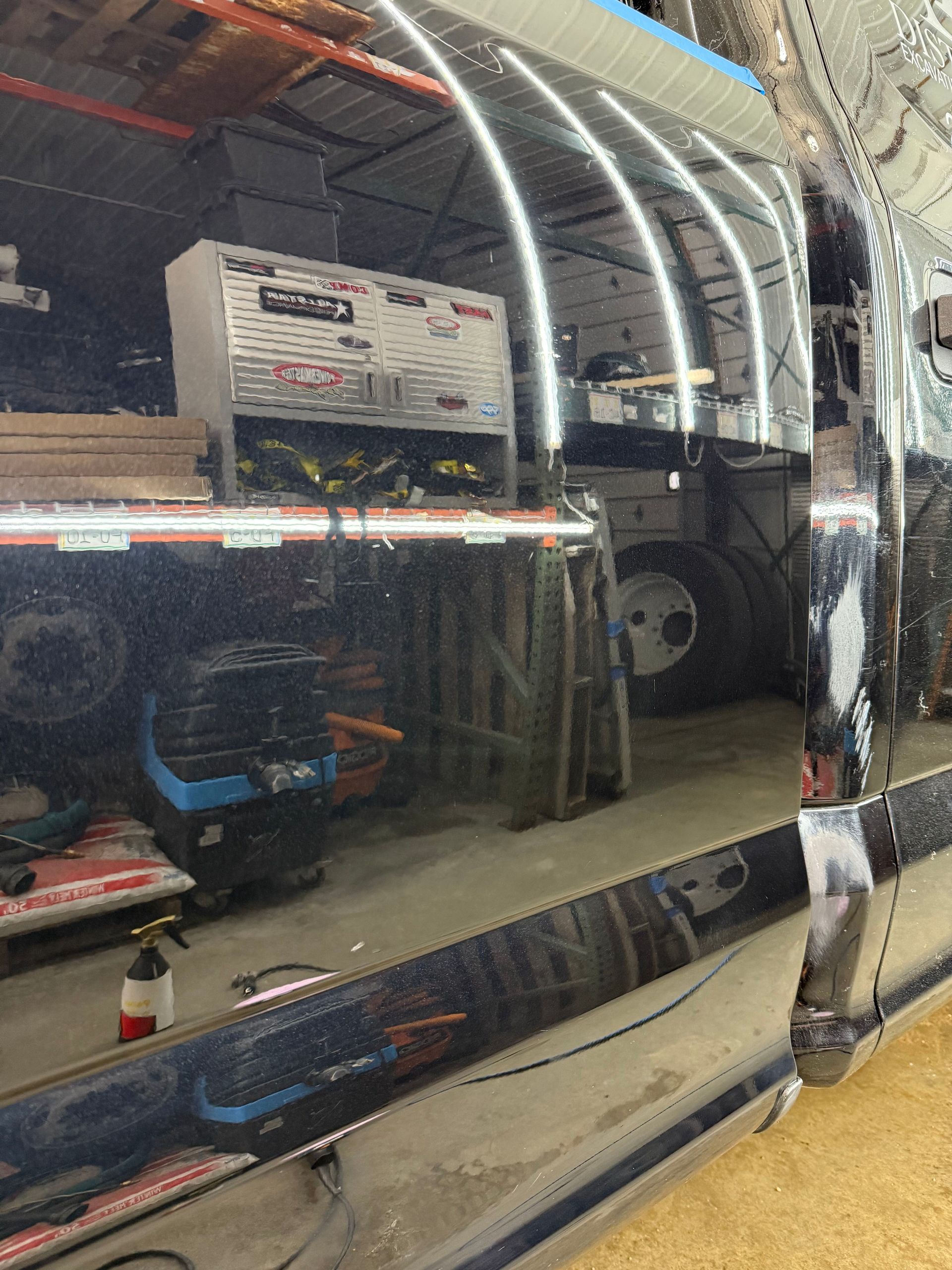 A truck is being worked on in a garage.