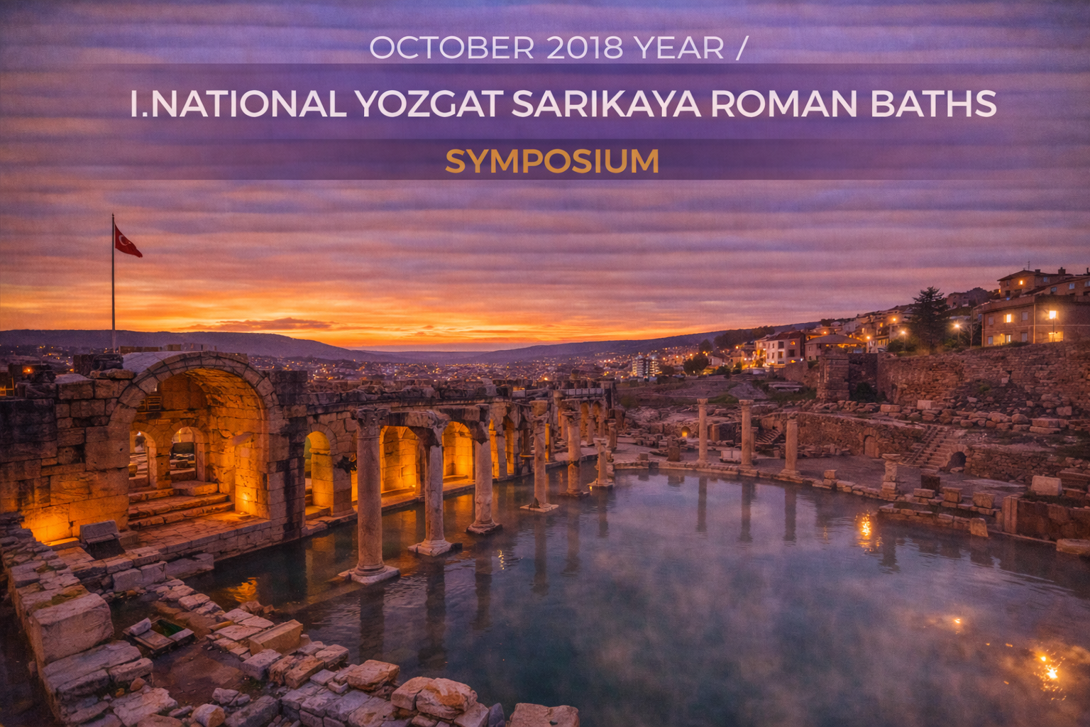 Yozgat Sarikaya Roman Baths at sunset, with illuminated ruins, water, and cloudy sky.