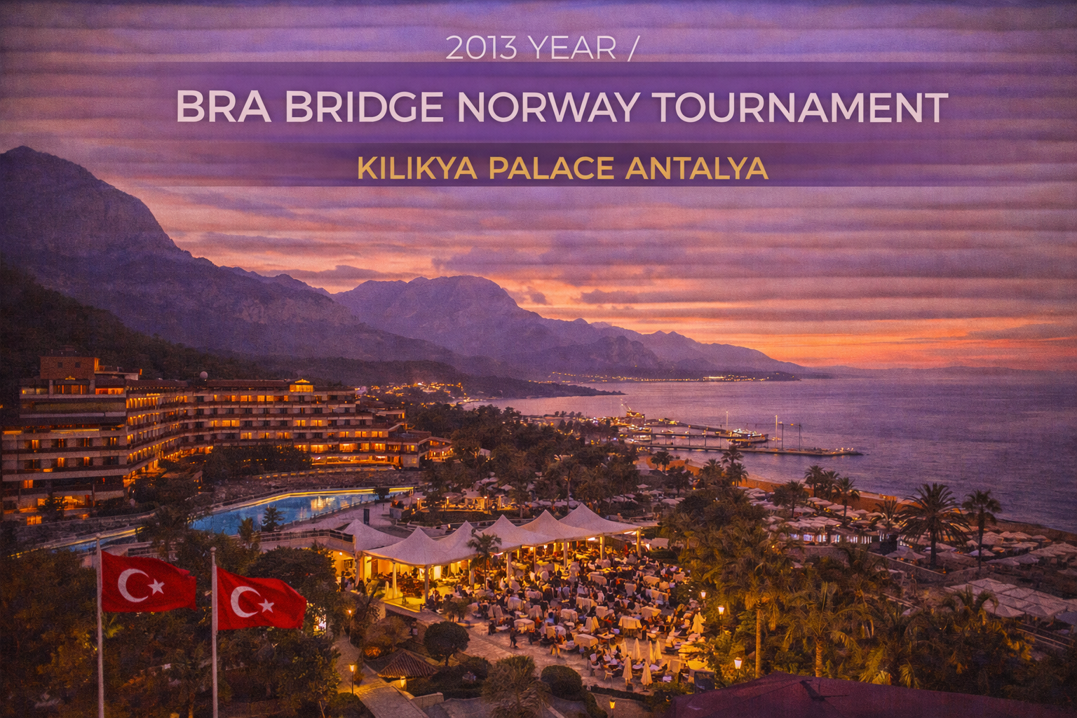 Sunset view of a coastal resort in Antalya, Turkey, hosting a bridge tournament; Turkish flags in foreground.