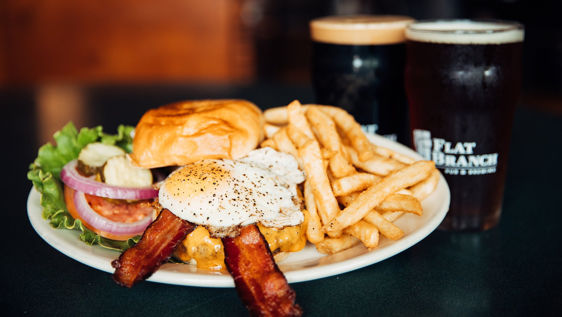 Find Delicious Food, Including Burgers With Eggs & Bacon & Fries at Flat Branch in Columbia, MO.