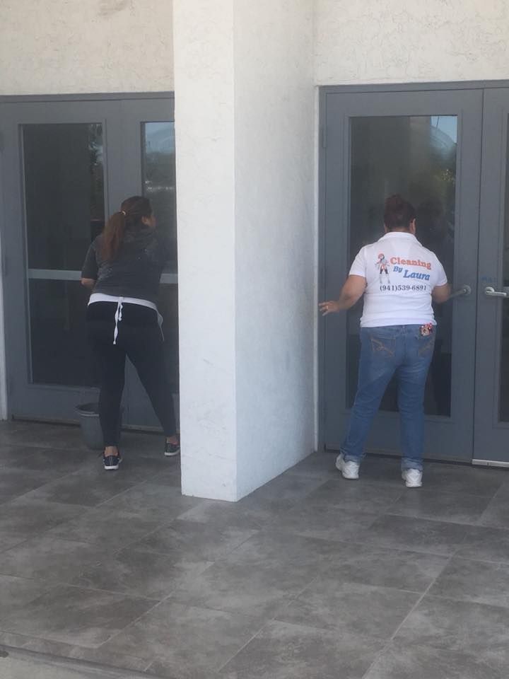 A woman wearing a shirt that says ' cleaning service ' on it