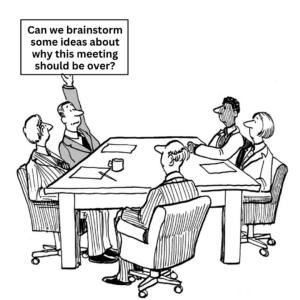 A group of people sitting around a table with a sign that says can we brainstorm some ideas about why this meeting should be over