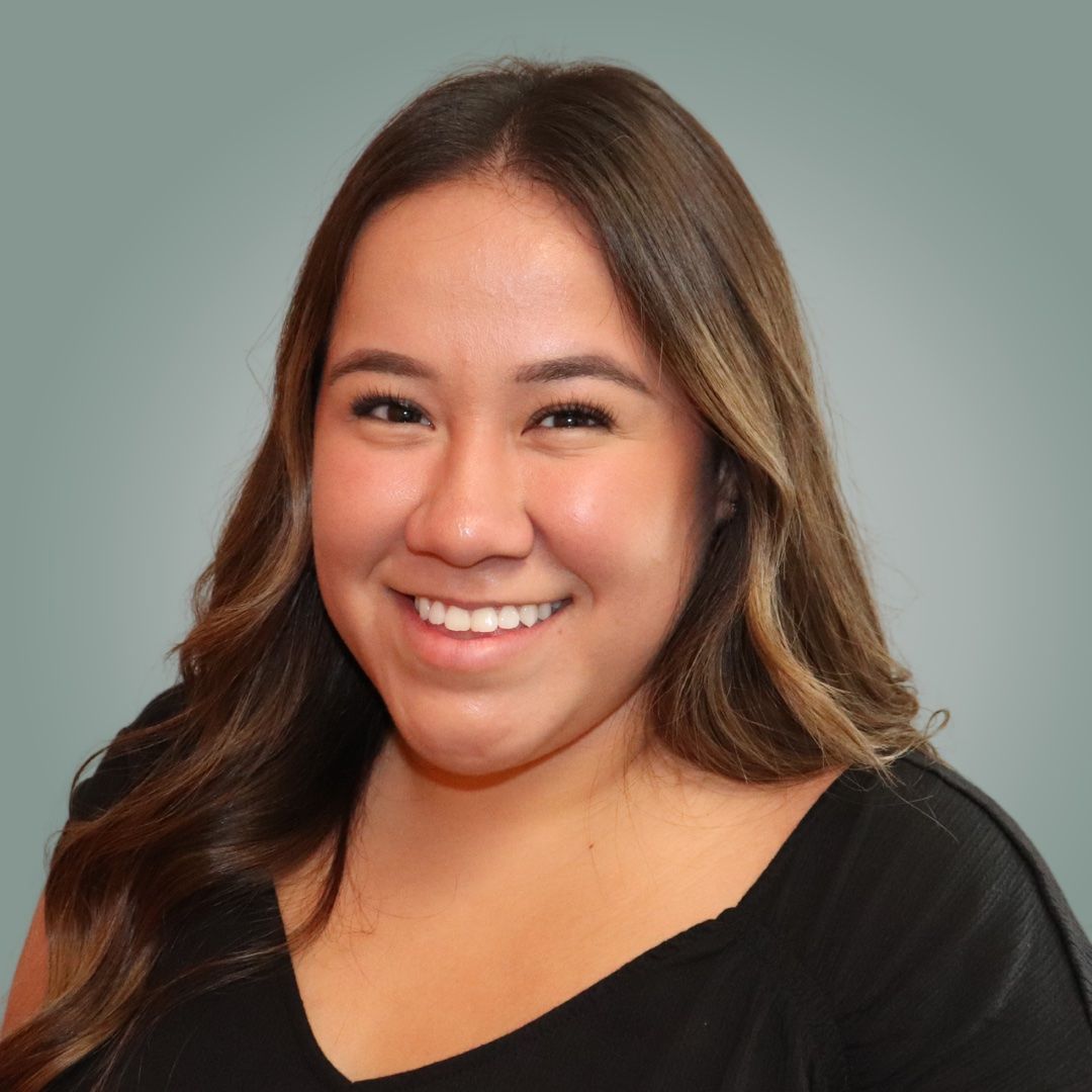A woman in a black shirt is smiling for the camera