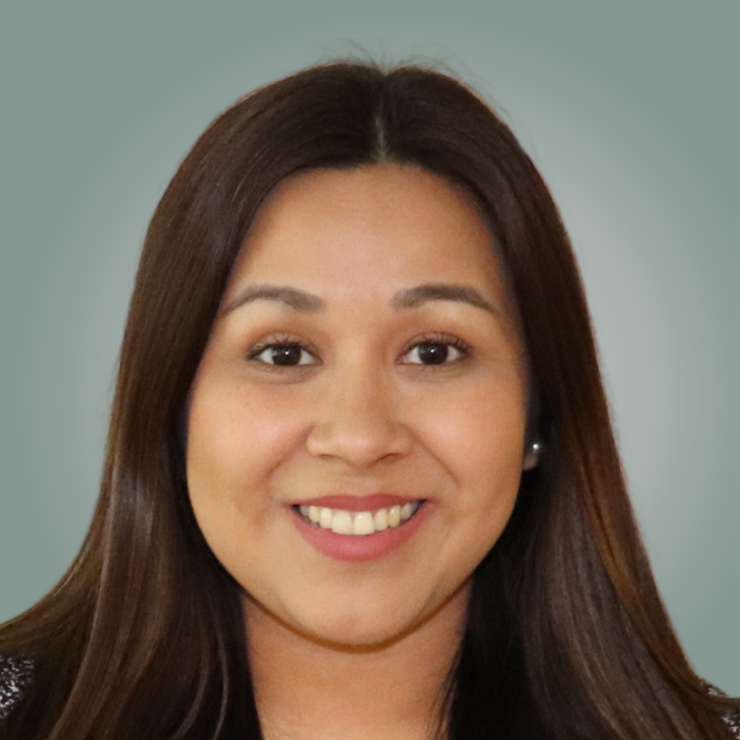 A woman with long brown hair is smiling for the camera