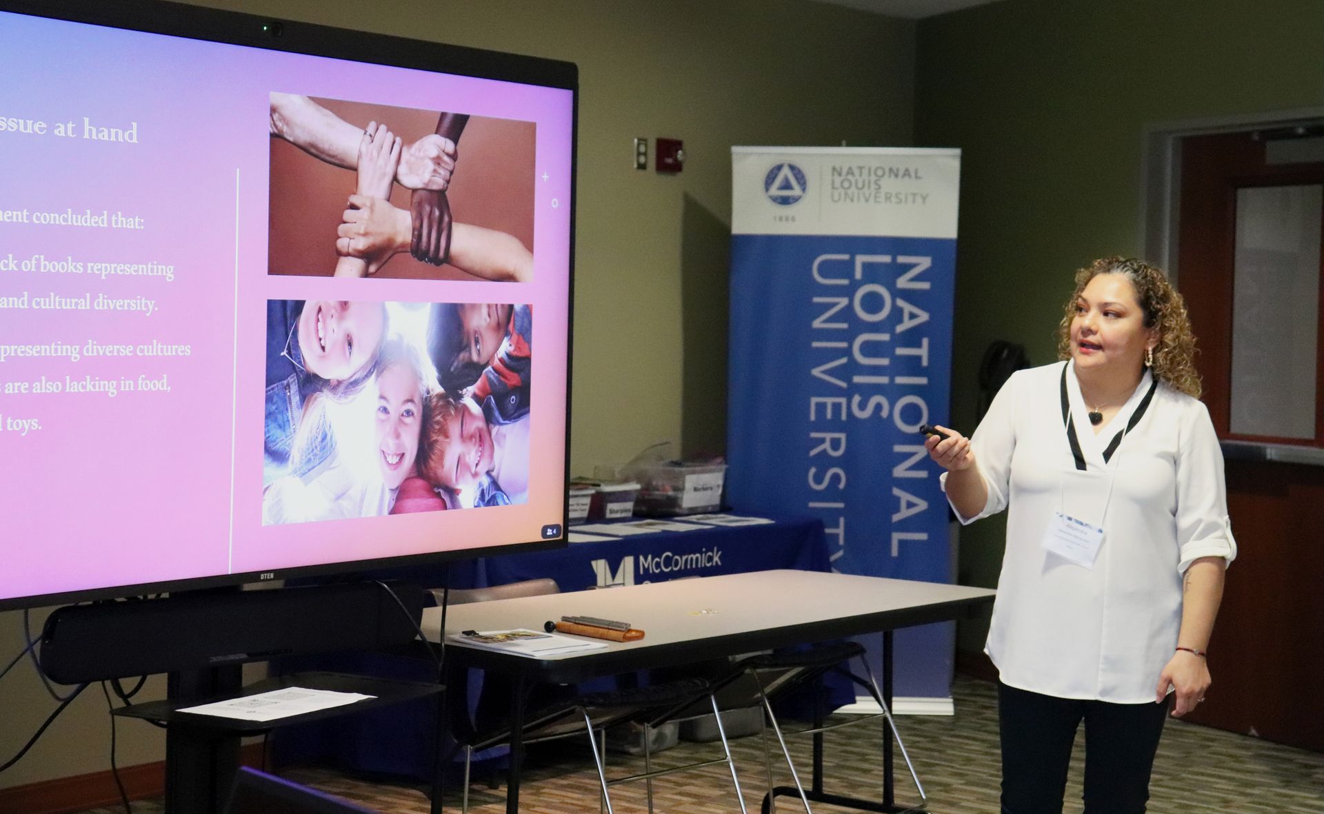 A woman is giving a presentation in front of a large screen. A woman is giving a presentation in front of a large screen.