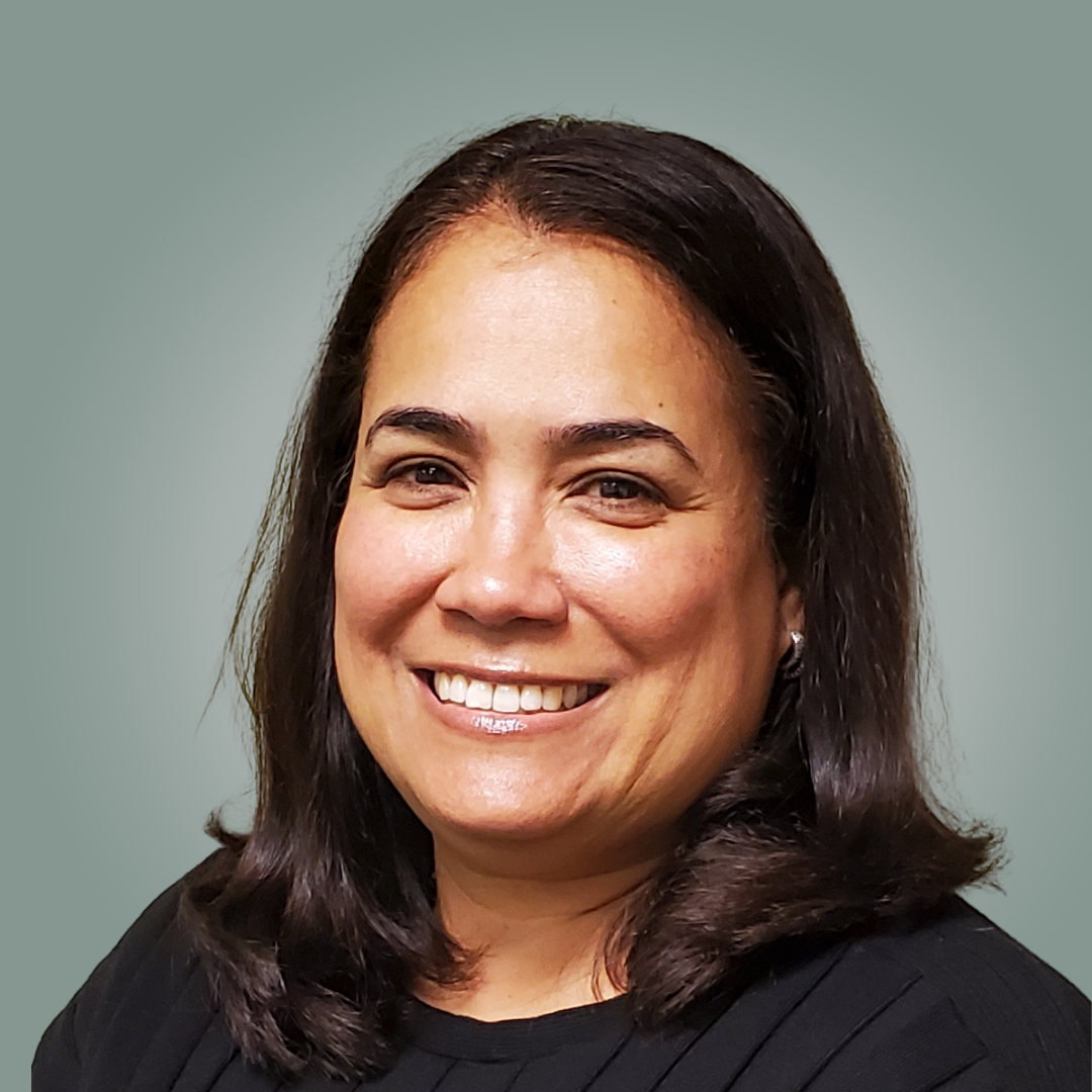 A woman in a black shirt is smiling for the camera