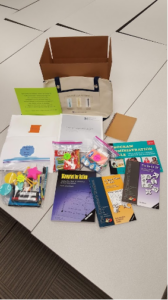 A cardboard box filled with a bunch of books and papers