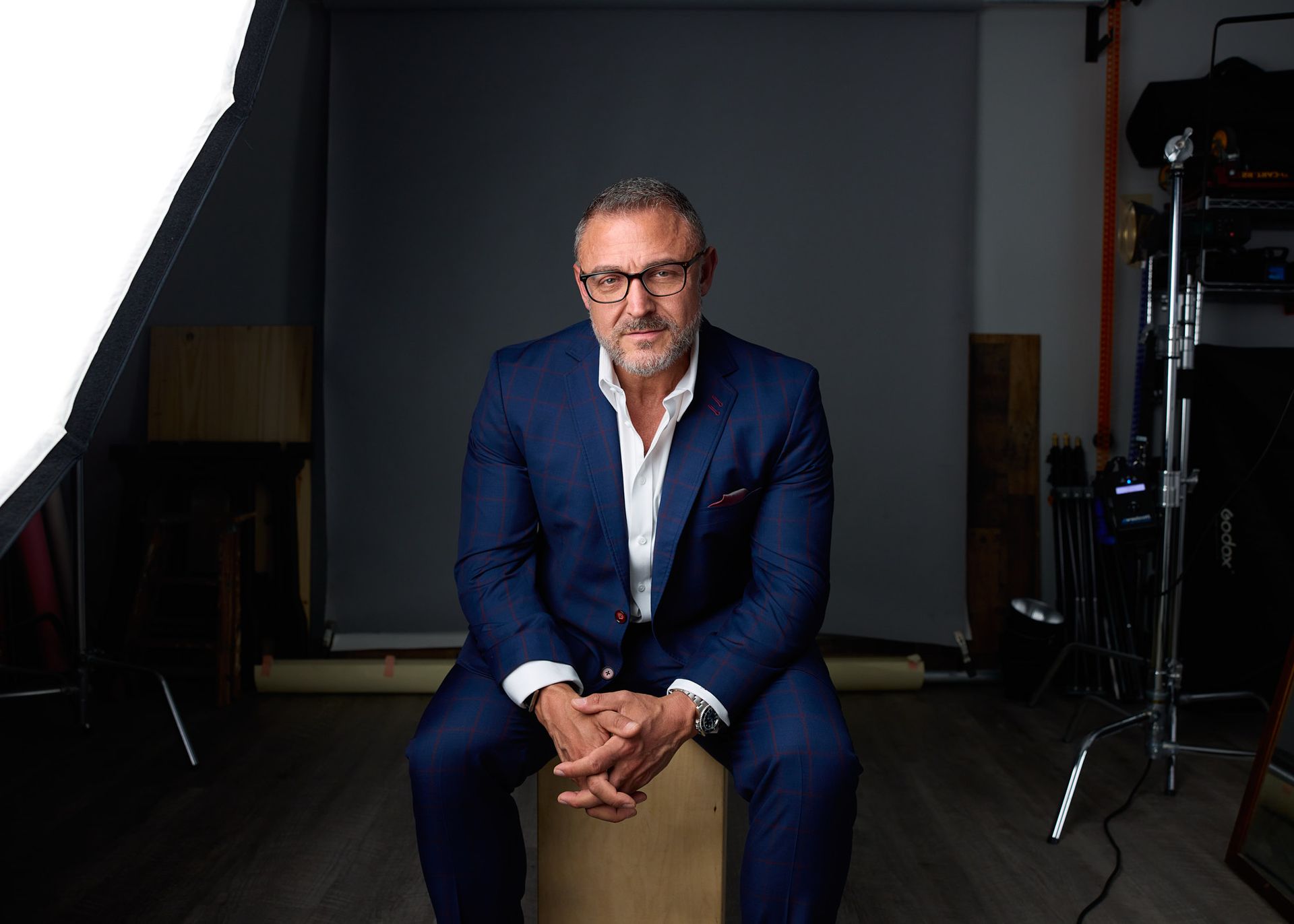 Man in glasses sitting in a studio