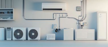 A white wall displays a collection of HVAC equipment, including outdoor compressor units, an indoor unit, and pipework.