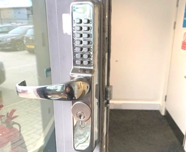 A close-up of a door with a digital key lock on it
