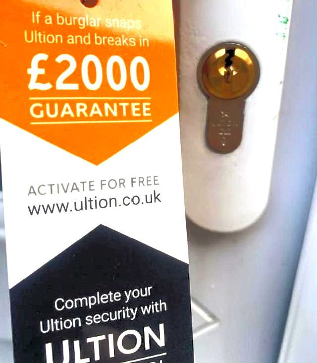 A person is holding a key with a tag that says £2000 guarantee