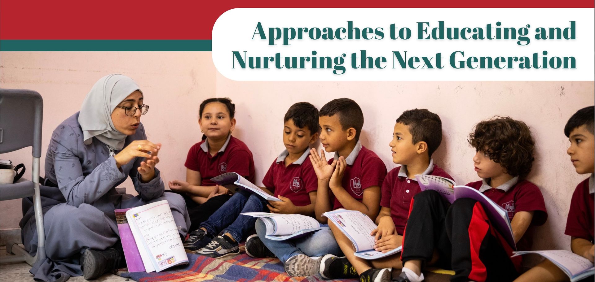 A teacher in a hijab leads a lesson with several children sitting on the floor.