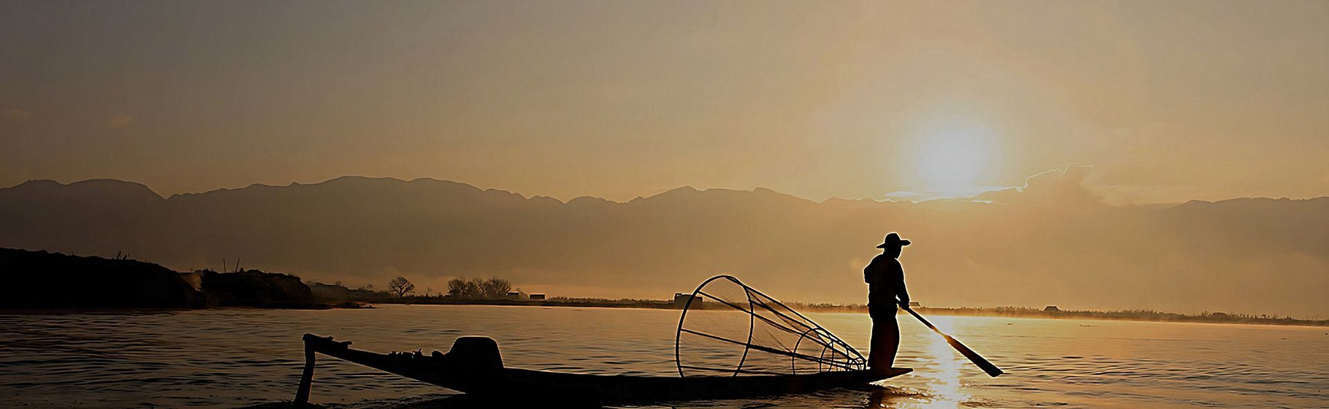 man on a boat paddling during sunset image