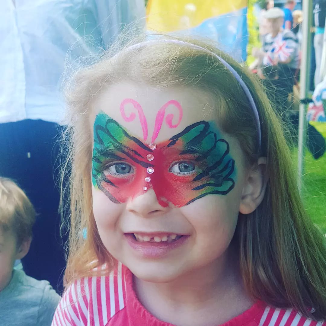 A little girl with a butterfly painted on her face