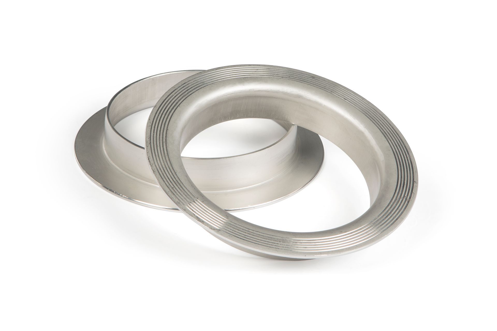 Two metal rings are sitting next to each other on a white surface.