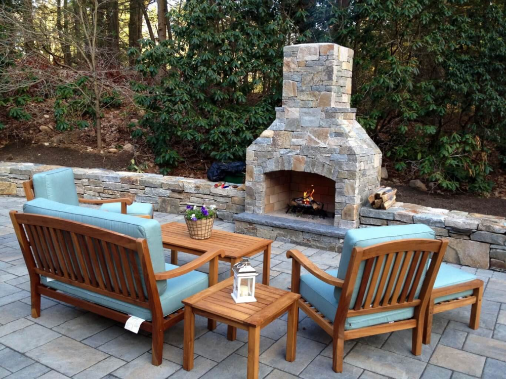 A wooden deck with a chair , table and chairs on it.