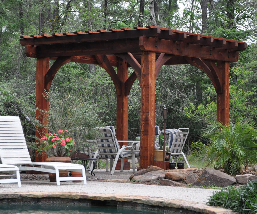 An aerial view of a patio with a pergola and a pool.