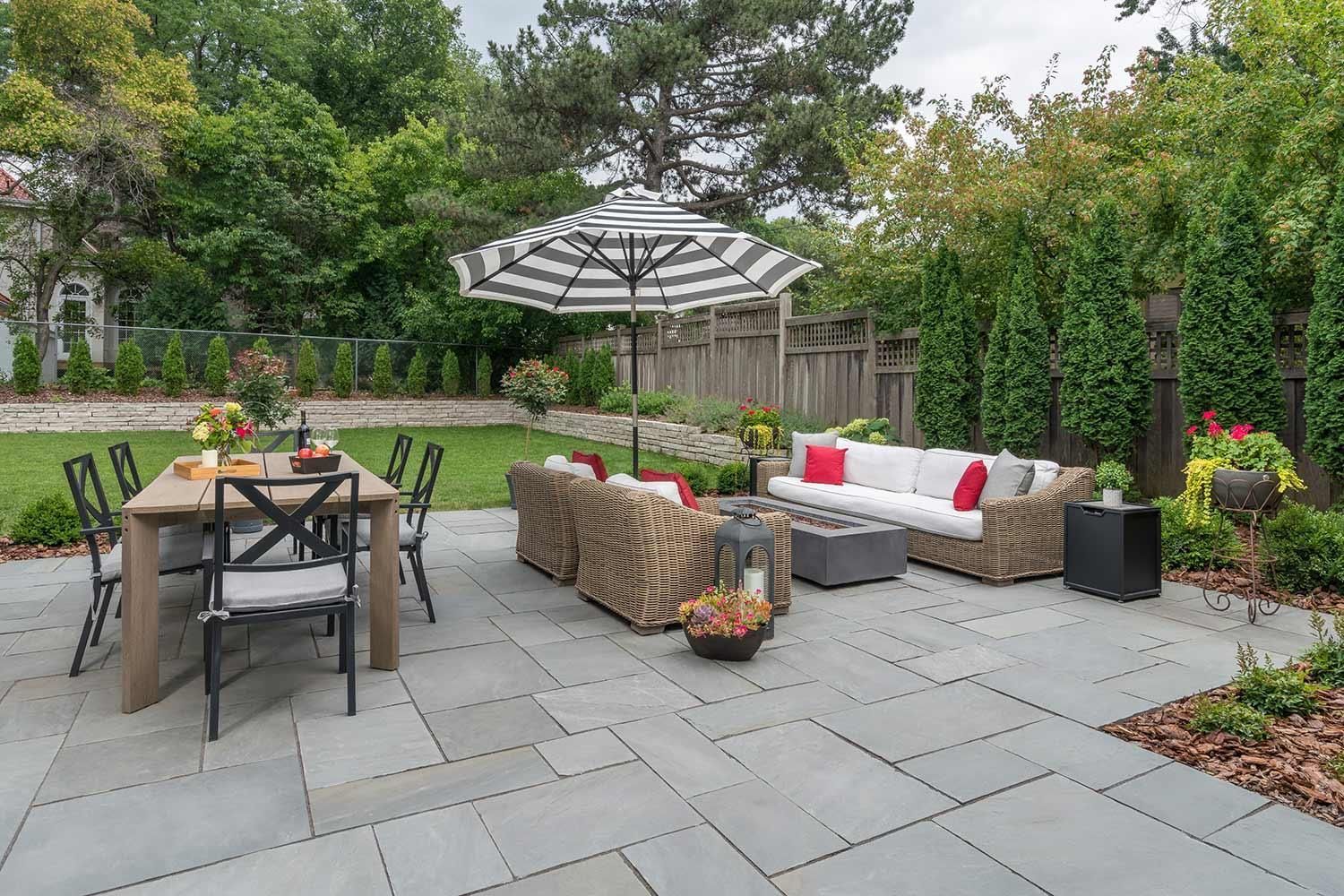 A wooden deck with a chair , table and chairs on it.