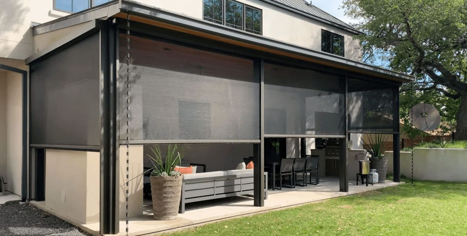 A fire pit is under a pergola in a backyard