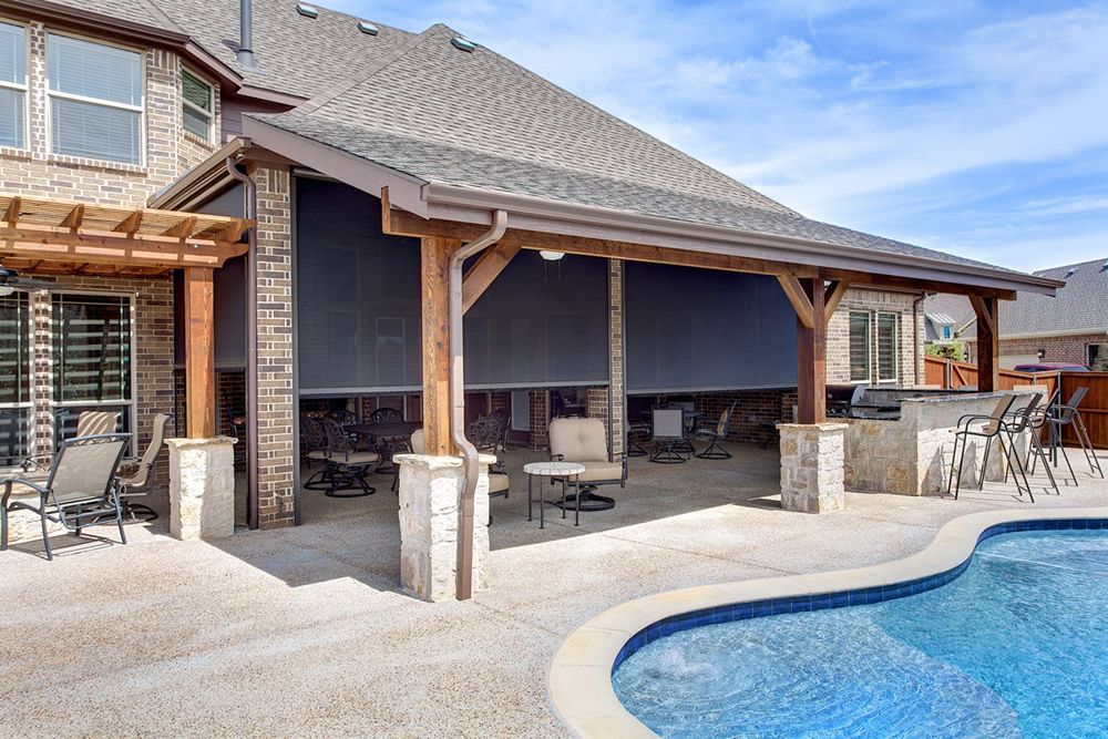 A wooden pergola is sitting in the middle of a backyard next to an air conditioner.