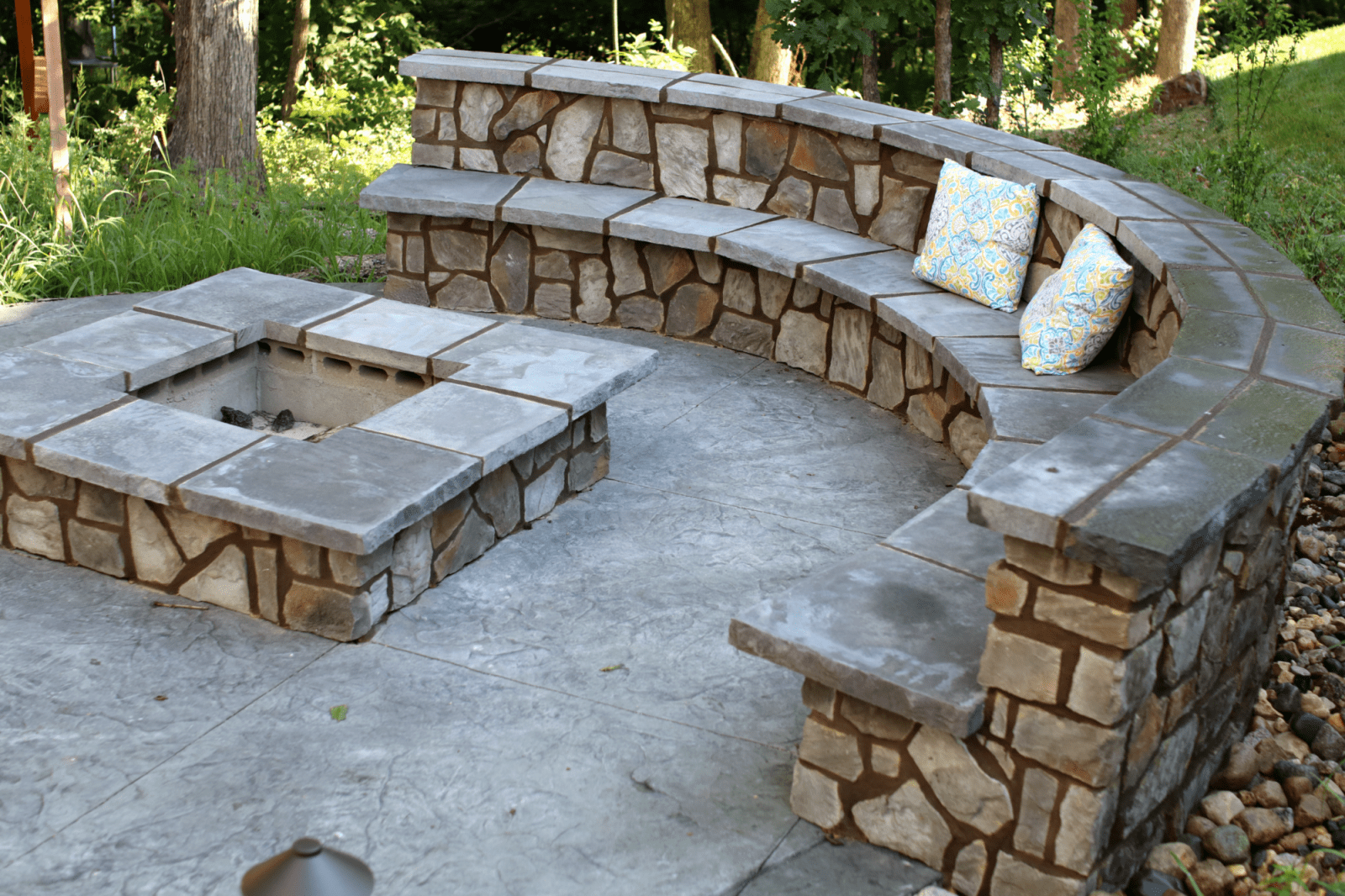 There is a fire pit in the middle of the patio.