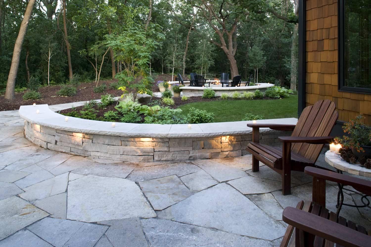 A deck with a couch , chairs , and a coffee table.