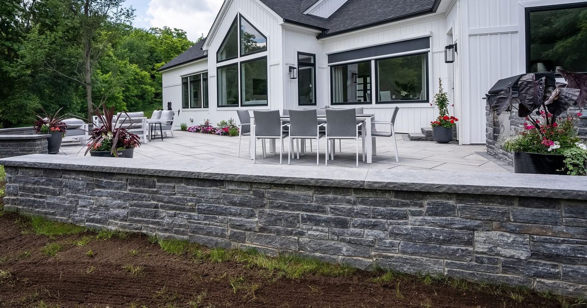 A large brick house with a large deck and patio area.